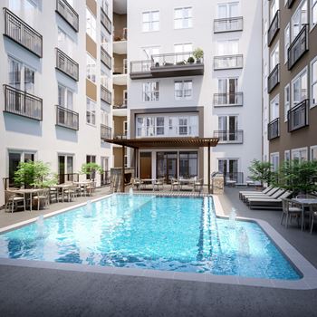 Courtyard swimming pool with surrounding lounge seating